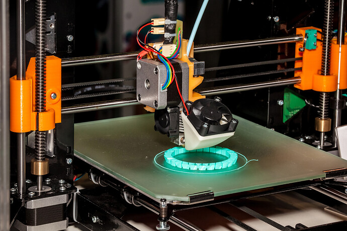 Close-up of a 3D printer extruding the first layer of a print