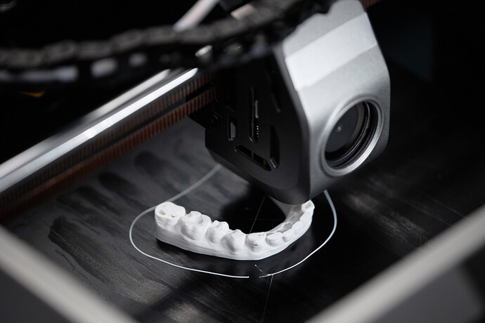 Macro close-up of a 3D printer extruder feeding filament